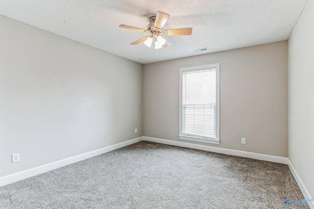 carpeted empty room featuring a textured ceiling and ceiling fan