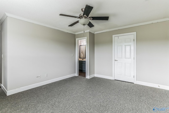 unfurnished bedroom featuring carpet floors, ensuite bathroom, ceiling fan, and crown molding