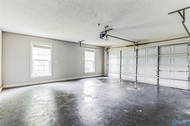 garage featuring a garage door opener and baseboards