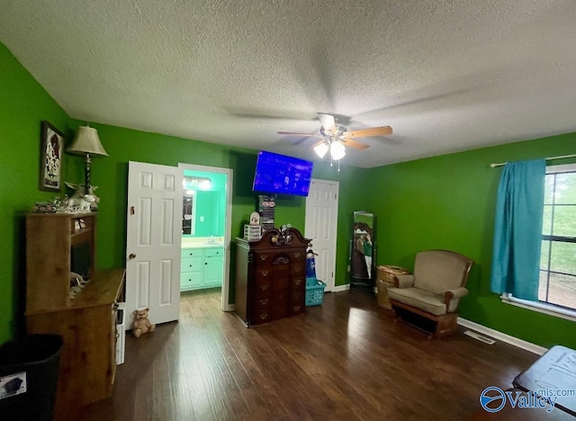 1055 Georgia Mountain Rd, Guntersville, AL 35976 - sitting room with wood finished floors, ceiling fan, a textured ceiling, and baseboards