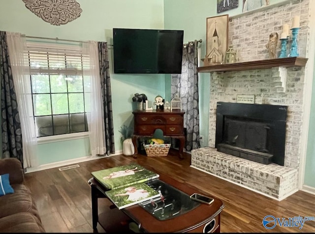 1055 Georgia Mountain Rd, Guntersville, AL 35976 - living area with wood finished floors, a fireplace, and baseboards