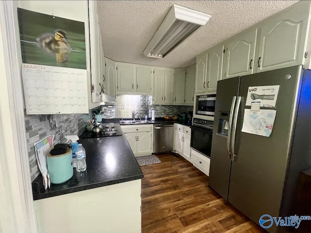 1055 Georgia Mountain Rd, Guntersville, AL 35976 - kitchen with black appliances, dark countertops, a sink, tasteful backsplash, and dark wood-style floors