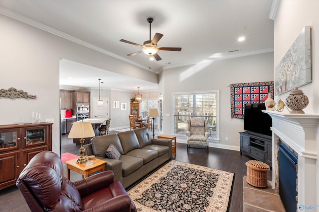 living room with crown molding, dark hardwood / wood-style floors, and ceiling fan