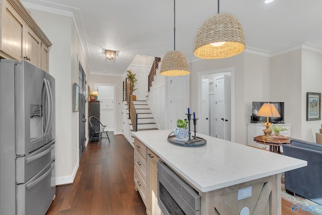 kitchen featuring hanging light fixtures, light brown cabinets, ornamental molding, appliances with stainless steel finishes, and a kitchen island