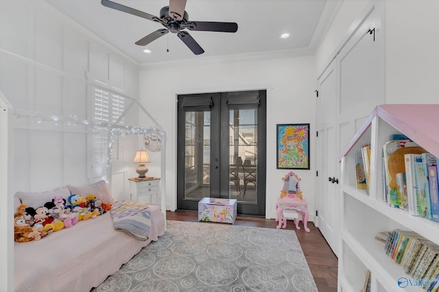 bedroom with dark hardwood / wood-style floors, access to outside, ceiling fan, crown molding, and french doors