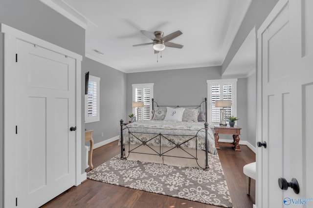 bedroom with crown molding, dark wood-type flooring, and ceiling fan