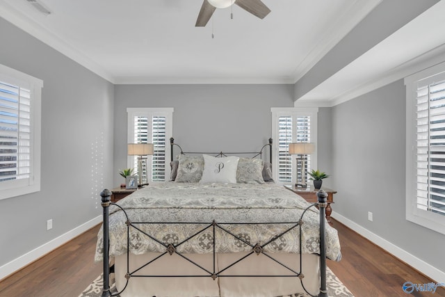 bedroom with crown molding, ceiling fan, and dark hardwood / wood-style flooring