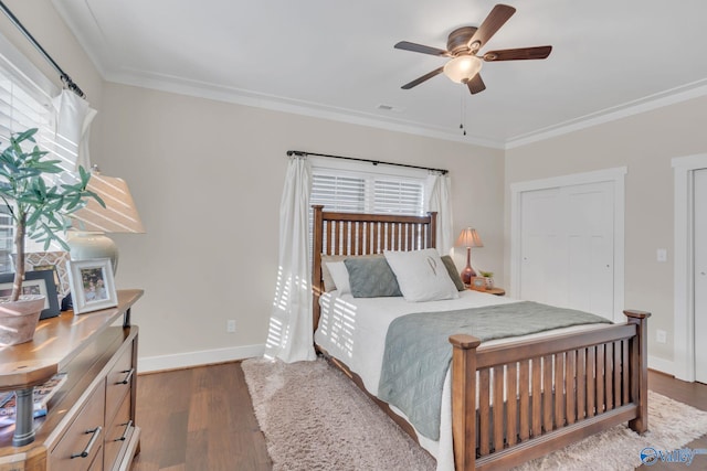 bedroom with multiple windows, crown molding, and dark hardwood / wood-style floors