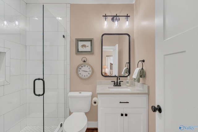 bathroom with vanity, an enclosed shower, and toilet