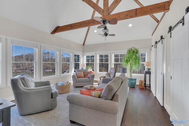 sunroom featuring lofted ceiling with beams, a barn door, and ceiling fan