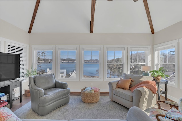 sunroom / solarium with lofted ceiling with beams and a water view