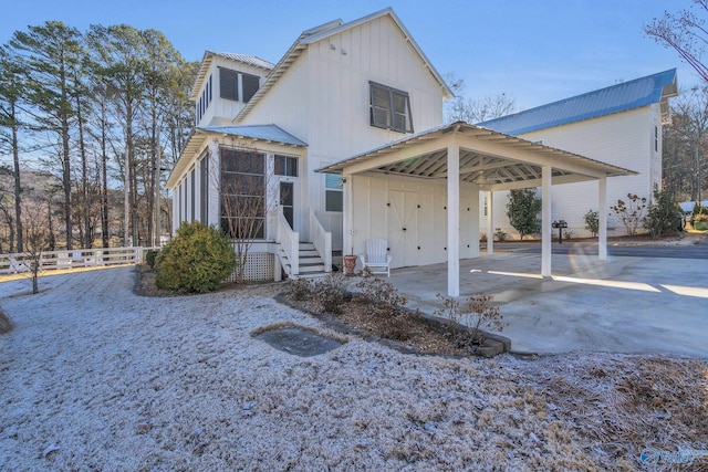 back of property featuring a carport