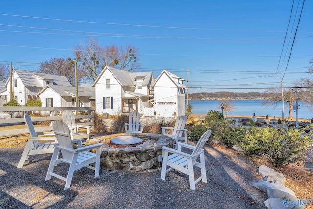 view of patio featuring a water view and a fire pit