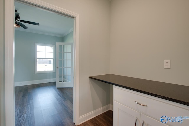 interior space featuring dark hardwood / wood-style flooring, ornamental molding, and french doors