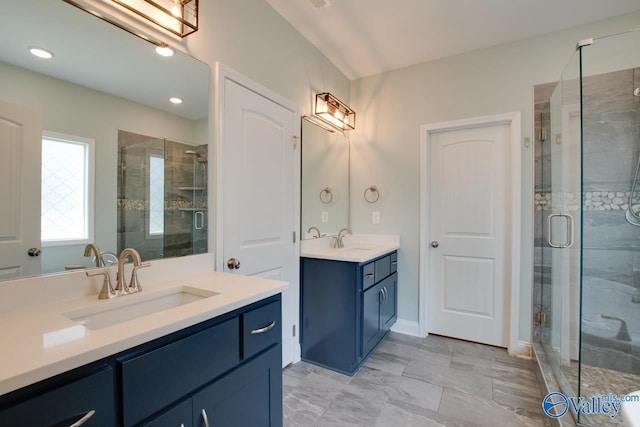 bathroom featuring vanity and an enclosed shower