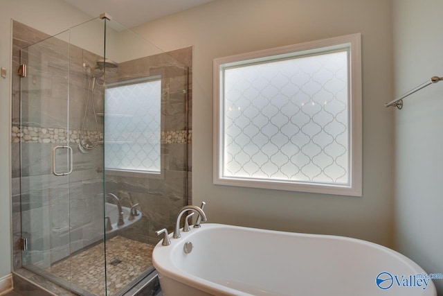 bathroom featuring independent shower and bath