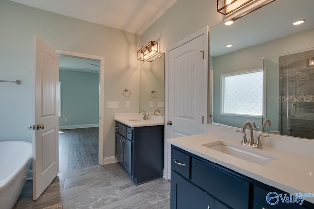 bathroom with shower with separate bathtub, vanity, and hardwood / wood-style flooring