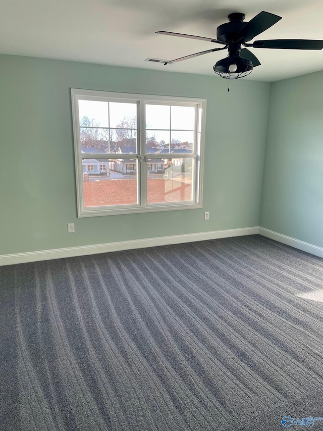 carpeted spare room with plenty of natural light and ceiling fan