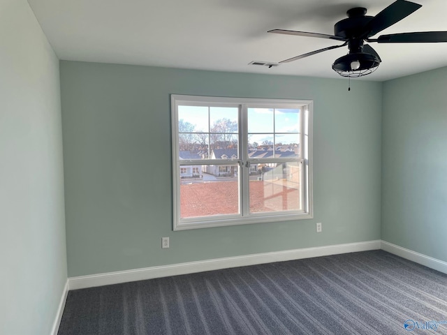 empty room featuring carpet flooring and ceiling fan