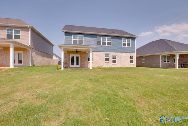 back of property featuring a yard, ceiling fan, and french doors