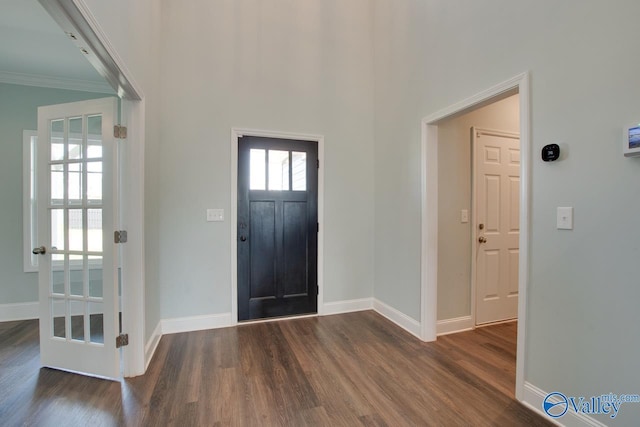 foyer featuring dark wood-type flooring and ornamental molding