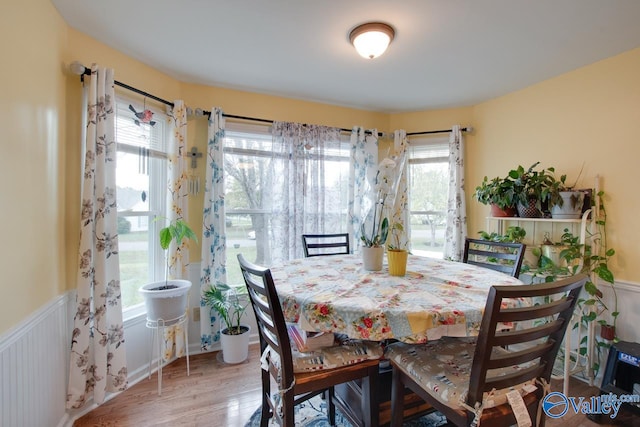 dining room with plenty of natural light and wood-type flooring