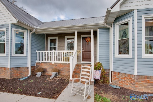 view of exterior entry featuring a porch