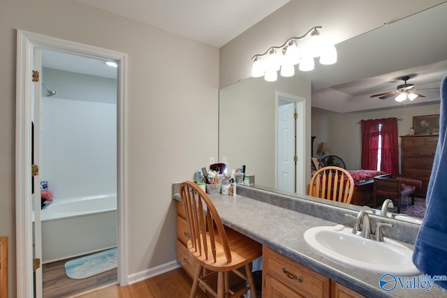 bathroom featuring ceiling fan, wood-type flooring, and vanity