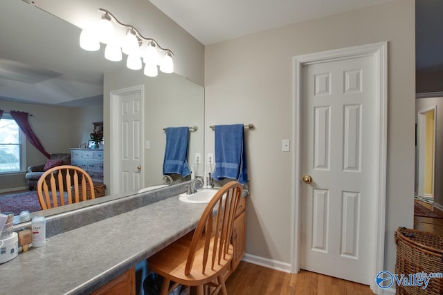 dining space featuring hardwood / wood-style flooring and sink