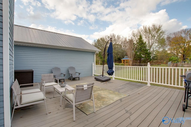 wooden terrace with a lawn