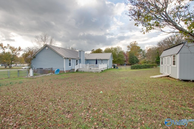 view of yard featuring a shed and a wooden deck