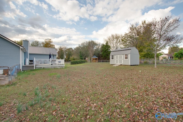 view of yard with a storage shed and a wooden deck