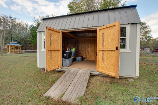 view of outbuilding featuring a yard and a gazebo