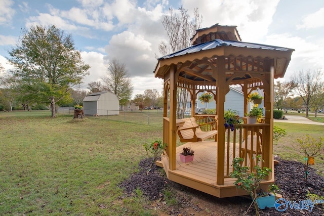 view of yard featuring a wooden deck, a shed, and a gazebo