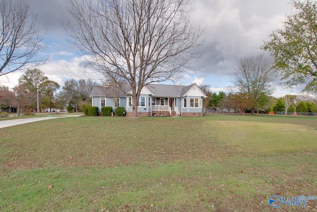 ranch-style home with covered porch and a front yard