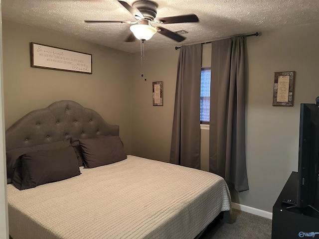 carpeted bedroom featuring ceiling fan and a textured ceiling