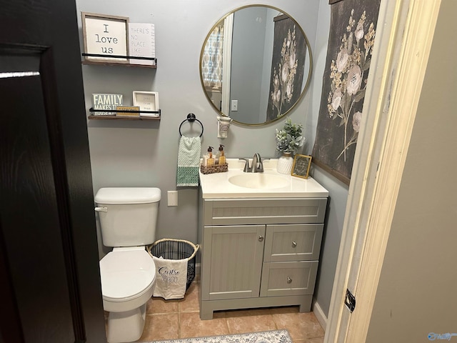 bathroom featuring vanity, toilet, and tile patterned flooring