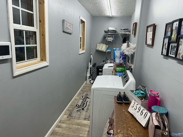 laundry room with dark hardwood / wood-style floors, separate washer and dryer, and a textured ceiling