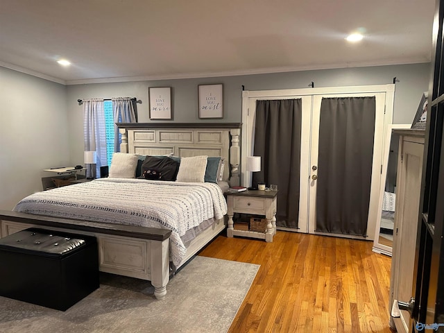 bedroom featuring crown molding and light hardwood / wood-style floors