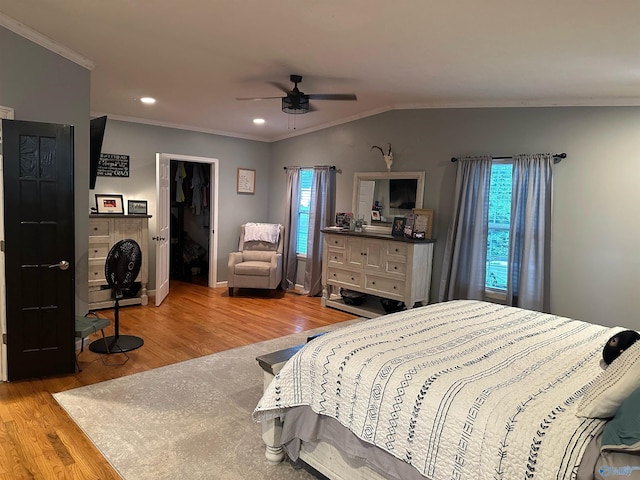 bedroom with crown molding, ceiling fan, lofted ceiling, and light wood-type flooring