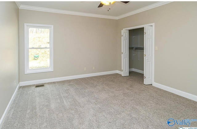 unfurnished bedroom with light carpet, ornamental molding, and ceiling fan