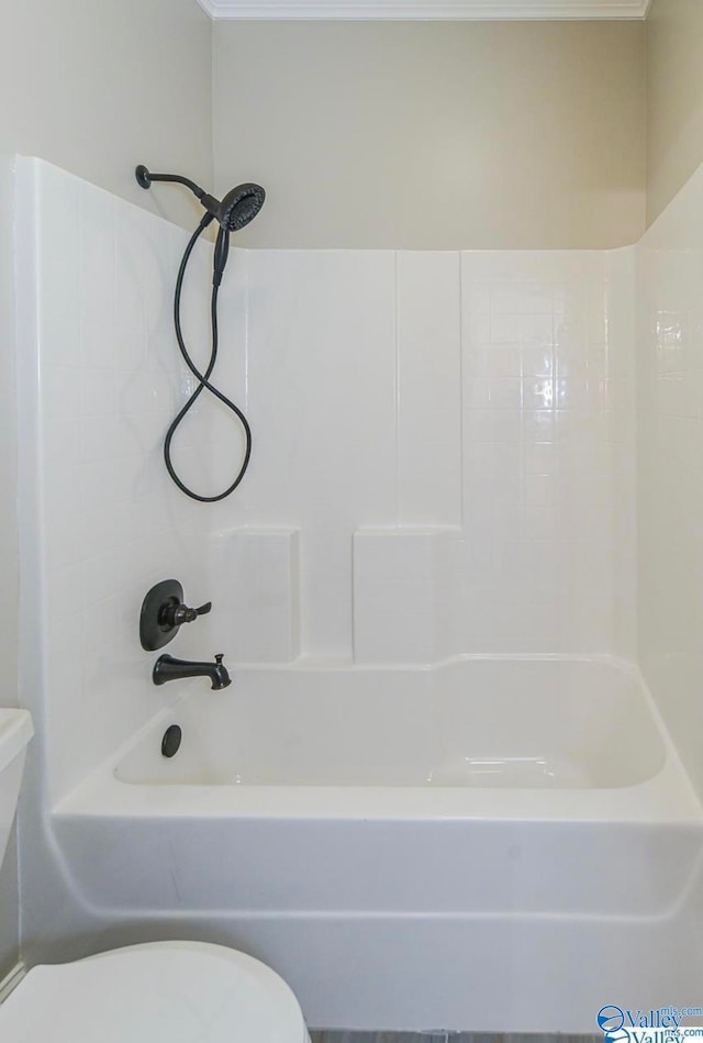 bathroom with washtub / shower combination and toilet