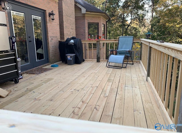 wooden deck featuring grilling area and french doors