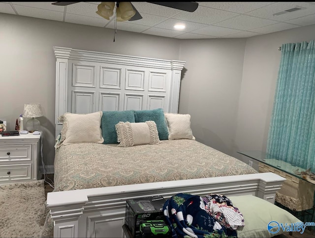 bedroom with a paneled ceiling and ceiling fan