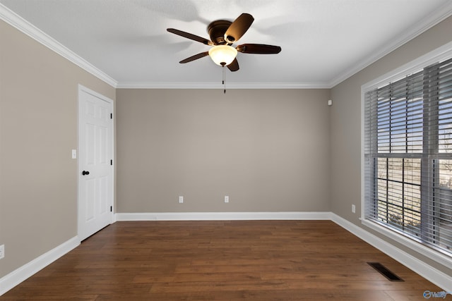 unfurnished room featuring ornamental molding, dark wood-style flooring, visible vents, and baseboards