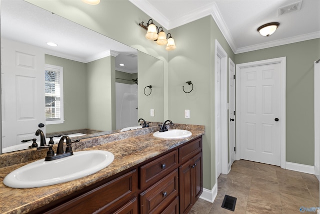 full bath with ornamental molding, visible vents, and a sink