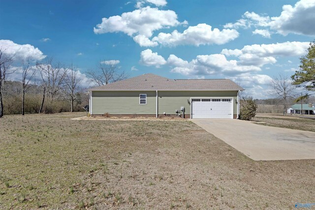 exterior space featuring concrete driveway and an attached garage