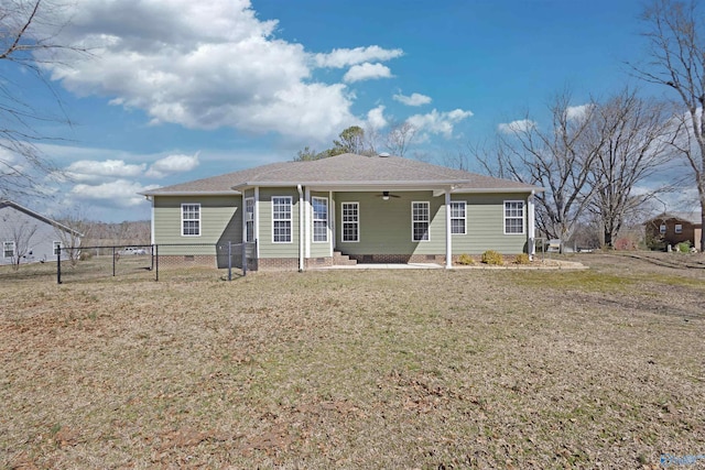 rear view of house with a yard, crawl space, fence, and a ceiling fan