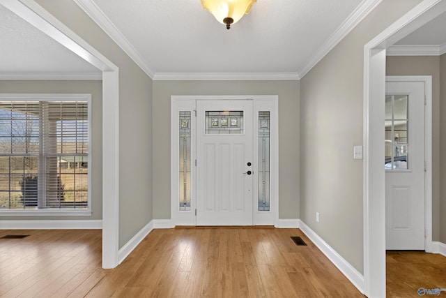 entrance foyer featuring light wood finished floors, baseboards, and visible vents