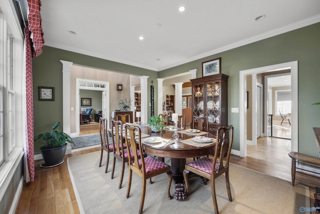 13032 Monte Vedra Rd, Huntsville, AL 35803 - dining space featuring light wood-type flooring, decorative columns, baseboards, and crown molding